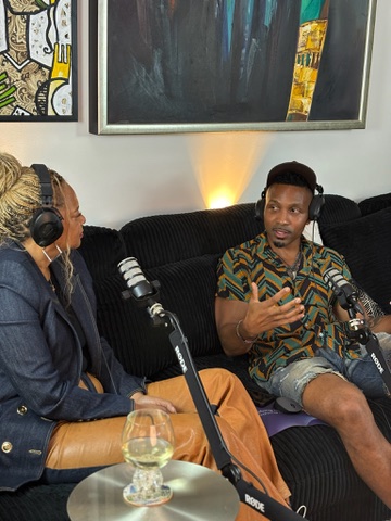 Host in conversation with a guest on the couch