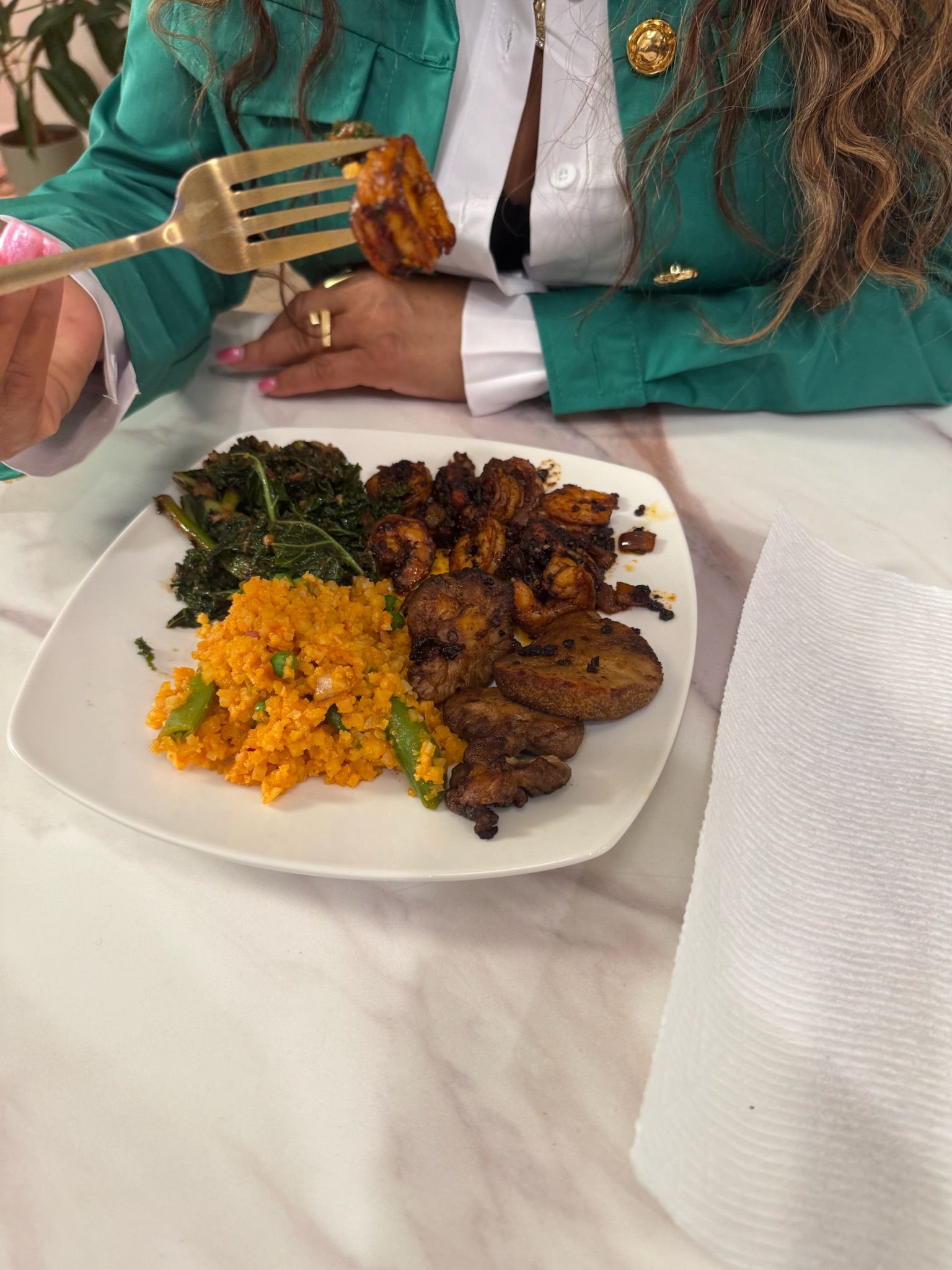 A plated meal held up with a fork during tasting